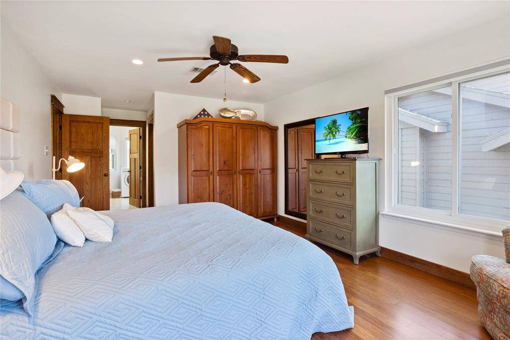 Step into the spacious primary bedroom.  Thanks to being a corner unit, there is extra sunlight from the updated, storm rated windows.