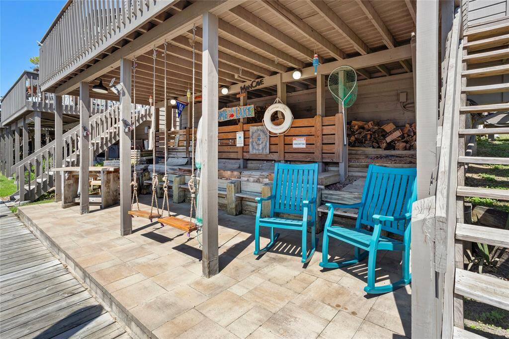 Let's head dockside and see the man cave "fish camp".  Enjoy this additional outdoor living space after returning from a day of boating. Custom seats built into the wall and swings make this one-of-a-kind space the envy of all your neighbors.