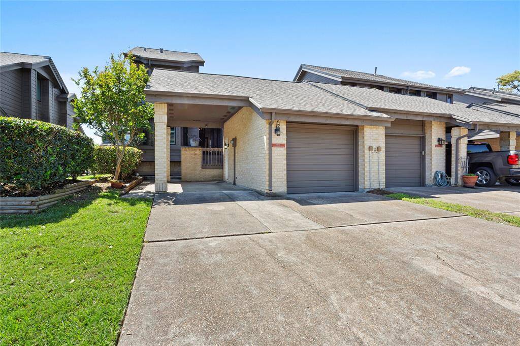 This townhouse offers a single-car garage, a covered carport, and double-wide driveway for extra parking.