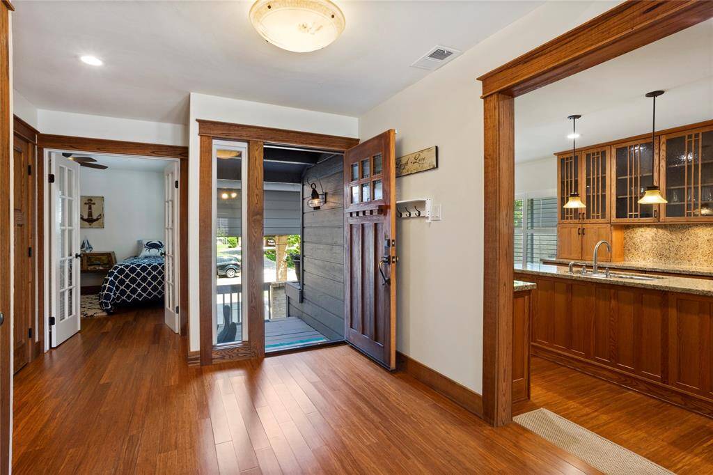 Behind the entryway, you will find the guest bedroom through french doors and the guest bathroom.