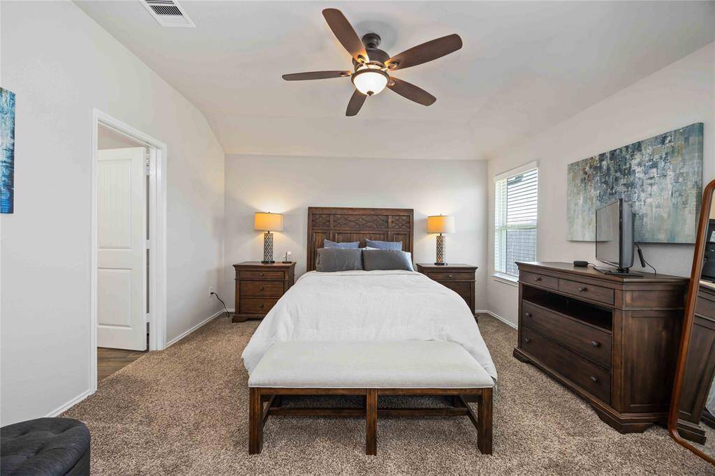 The generous primary bedroom offers plenty of space, complete with an ensuite bathroom for added privacy and convenience.