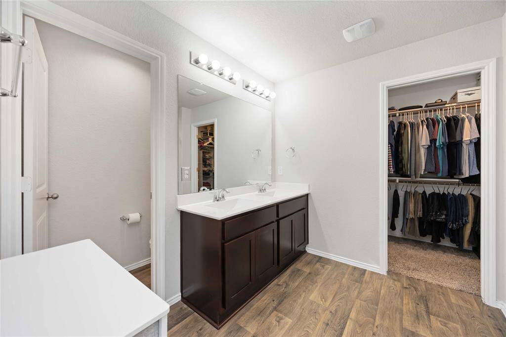 Enjoy the ease of a thoughtfully designed primary bath with a spacious walk-in closet located just at the right corner.