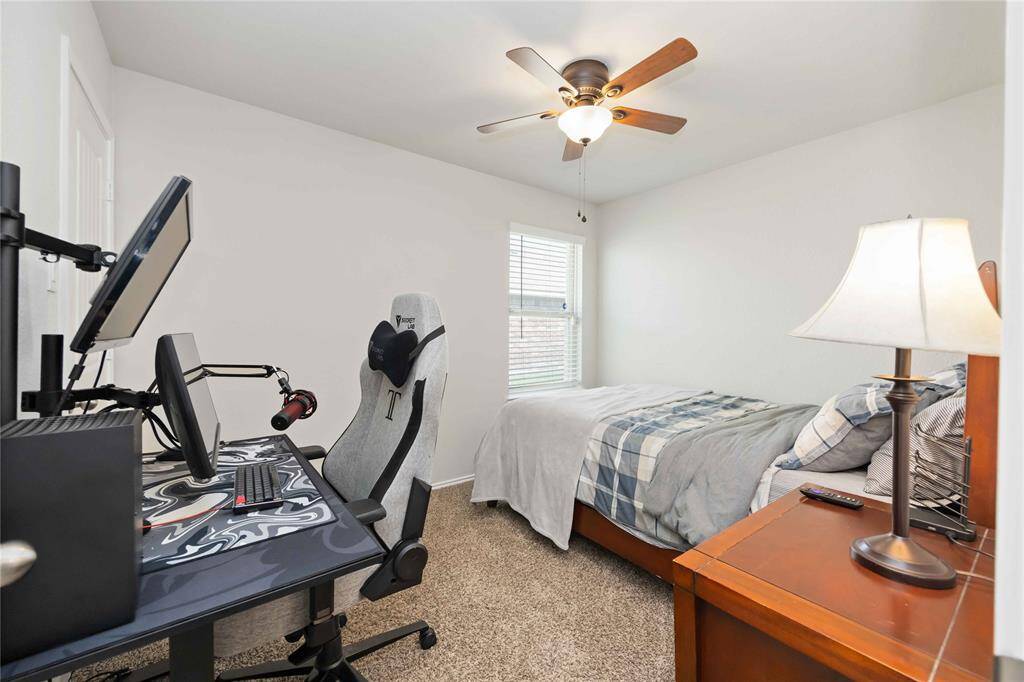 Bedroom 2  offers plush carpet flooring and a high ceiling.