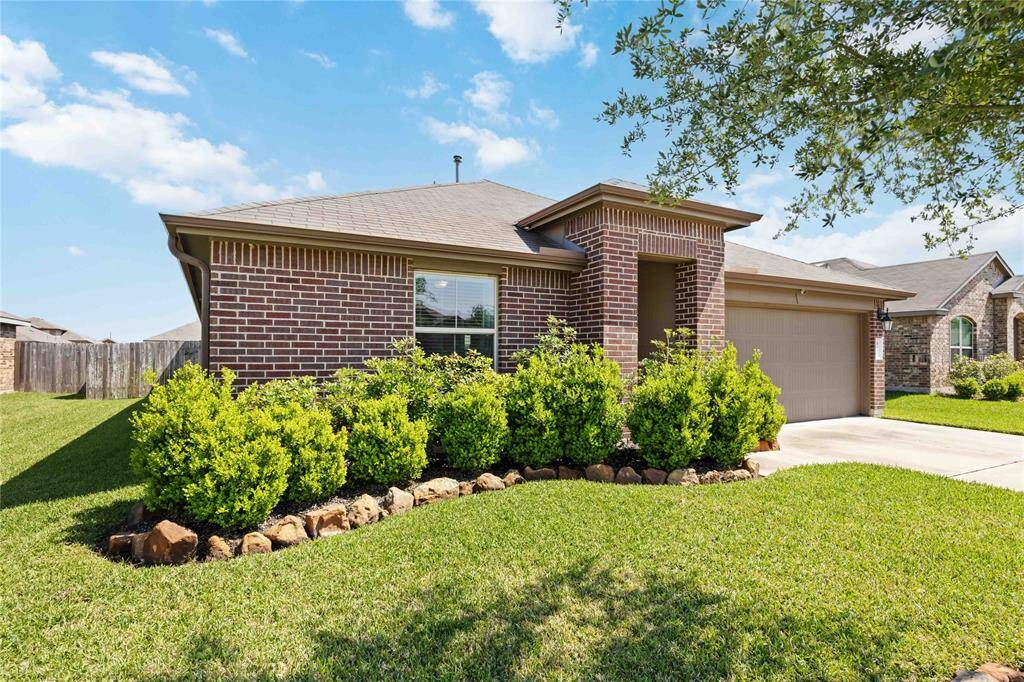 Enjoy a lush green lawn, neatly trimmed shrubs, and a landscaped tree bed that adds character and a welcoming touch to the front yard.