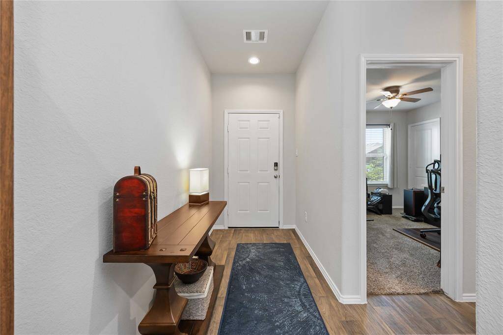 Inviting entryway featuring warm, rich-toned wood flooring that adds a touch of elegance and charm.