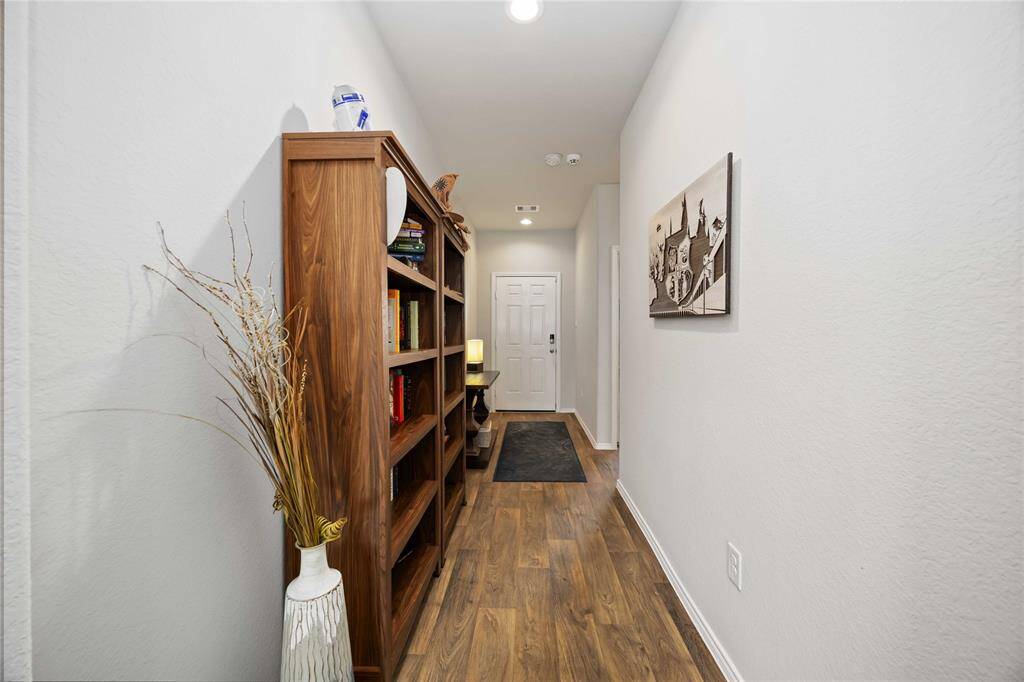 Welcome guests through a bright and welcoming foyer featuring a high ceiling and durable wood flooring.