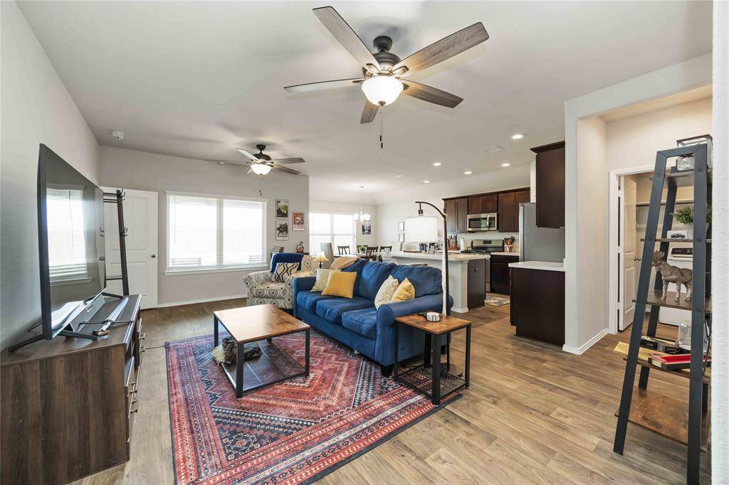 The living area effortlessly flows into the kitchen and dining spaces, allowing for a cohesive and connected lifestyle perfect for gatherings and family time.