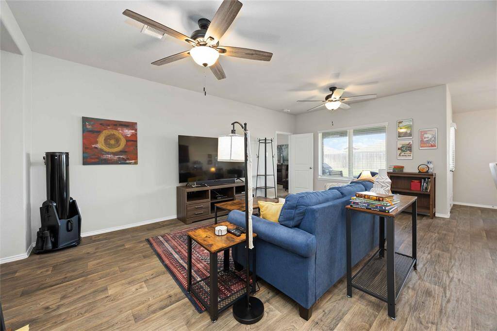 Enjoy the comfort of two ceiling fans and an abundance of natural light pouring in through the expansive windows, creating a bright and cozy gathering space.