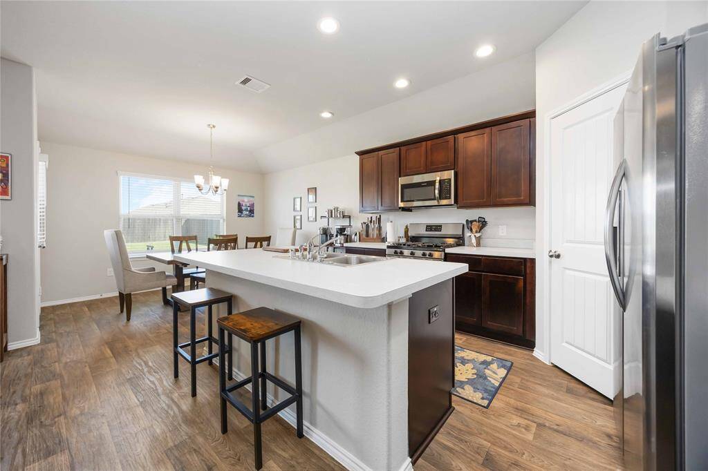 Enjoy the functionality of a kitchen-dining combo that keeps everyone connected during mealtime, whether it's a quick bite or a festive dinner with family and friends.