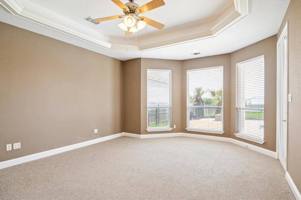 So much natural light brought in to the primary bedroom with these large windows.