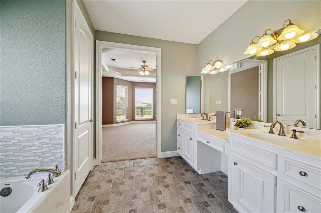 Primary bedroom with lighting in the tray ceiling, a door going to the pool and back patio.