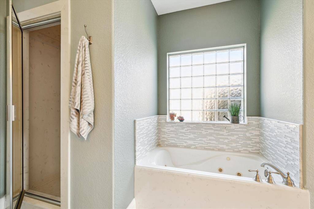 Check out the STEAM SHOWER and jetted garden tub in your primary ensuite.