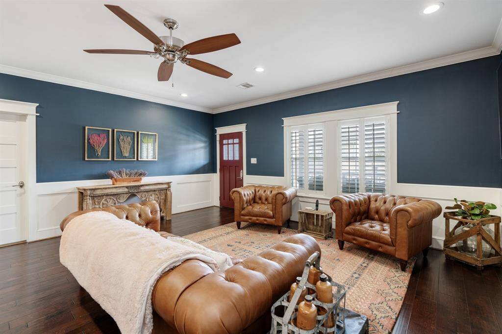 Showcasing rich architectural details, this beautifully designed living space includes recessed lighting, large windows and plantation shutters.