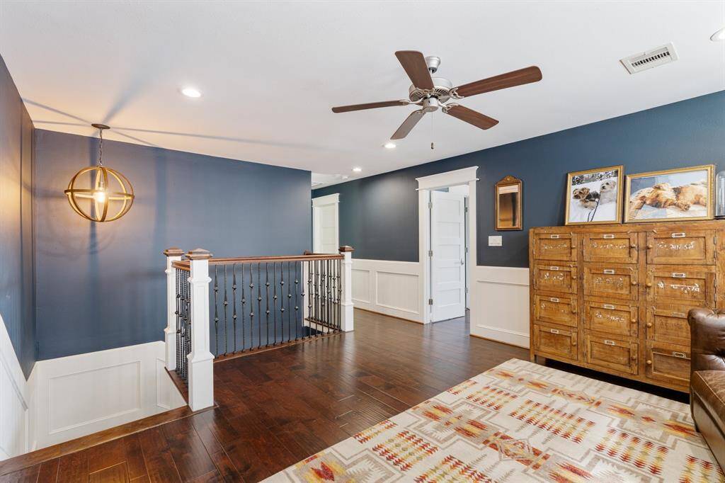 Overlooking the staircase, this charming second-floor space seamlessly connects to the home's upper-level rooms. The elegant railing, classic trim work, and warm lighting contribute to the home's timeless appeal.