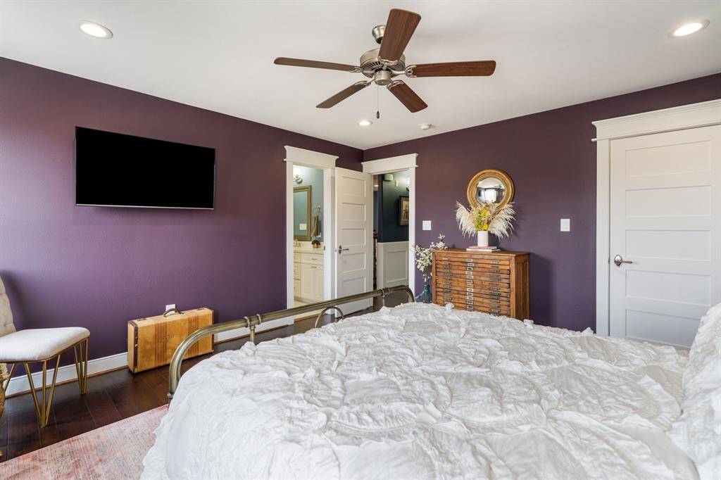This secondary bedroom highlights the seamless flow into the en-suite bath, framed by elegant molding. The spacious layout provides a luxurious escape at the end of the day.