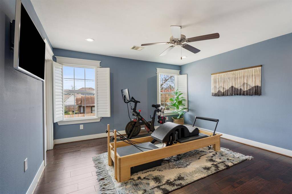 This fourth bedroom is currently being used as a fitness room. Oversized windows invite natural light, while the neutral tones create a calming atmosphere.  Bedroom includes a spacious closet.
