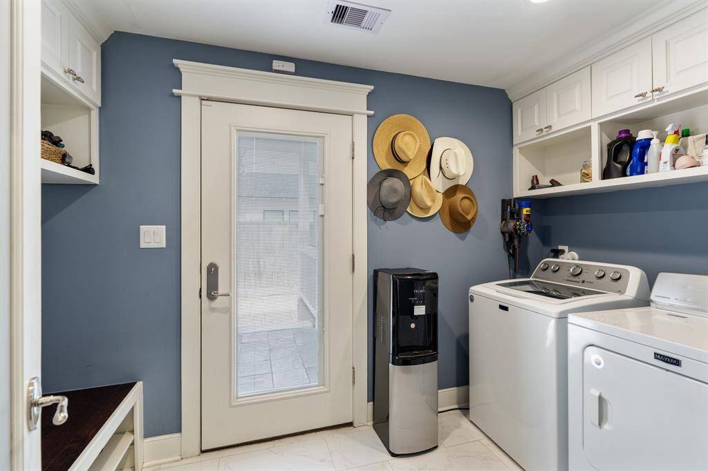 This well-equipped utility room offers an abundance of storage. Practical and stylish, it makes household tasks effortless.