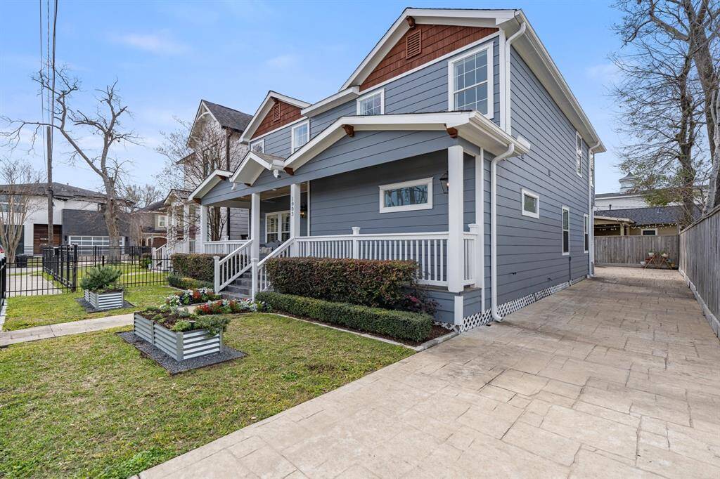This beautifully maintained home boasts timeless architectural details, a well-manicured front yard, and an extended private driveway leading to a gated backyard.
