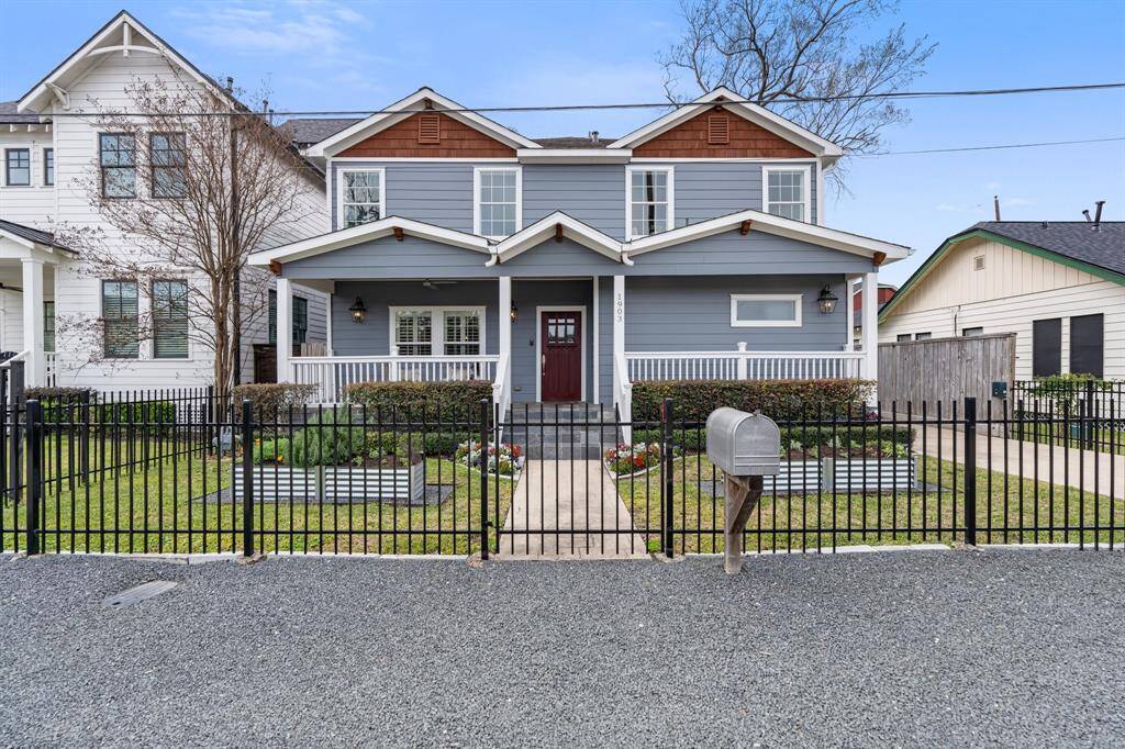 This beautifully designed two-story home boasts a welcoming front porch, manicured landscaping, and a gated front yard. Its thoughtful architectural details and inviting entryway create an undeniable sense of warmth and character.