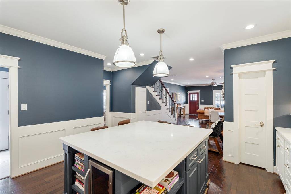 The expansive island serves as the centerpiece of this stunning kitchen, offering ample prep space, built-in shelving, and additional storage. The open-concept design allows for effortless flow between the kitchen, dining, and living areas.