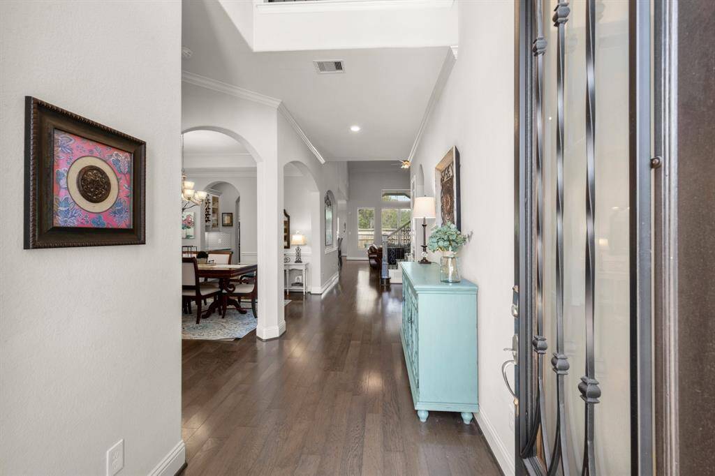 Welcome guests through a grand wooden door accented with beveled glass for a warm and elegant first impression.