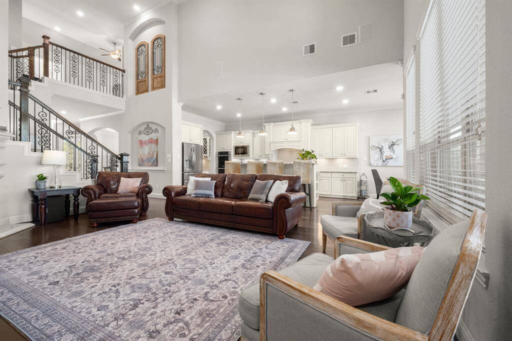 The living room is the heart of the home, seamlessly connected to the kitchen and oversized breakfast area in a bright, open floorplan.