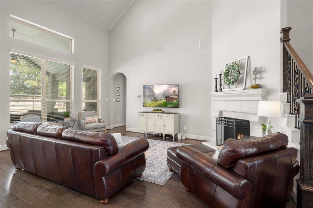 A stunning stone-cast gas log fireplace anchors the corner, adding warmth and character to the space.