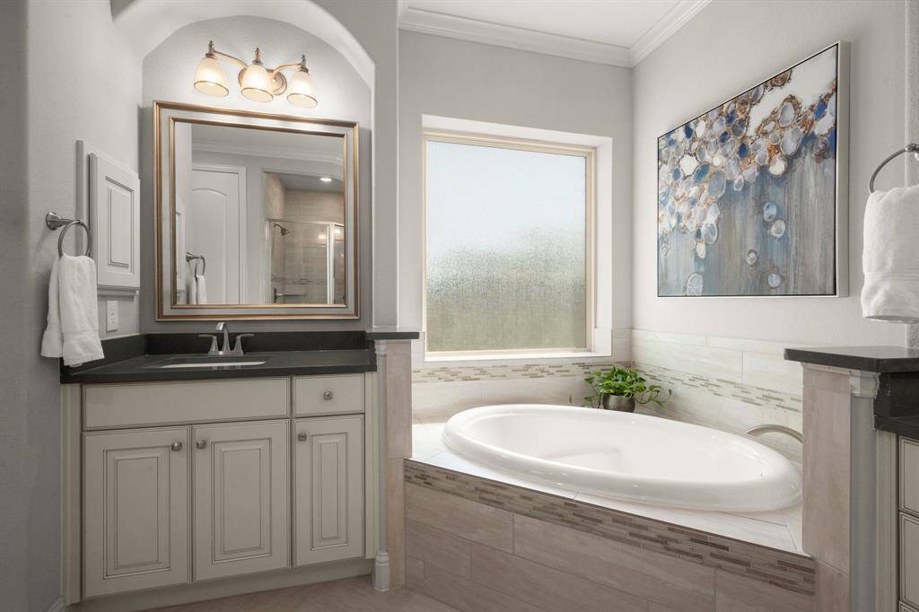 A soaking tub and a spacious walk-in shower with a bench provide spa-like luxury at home.