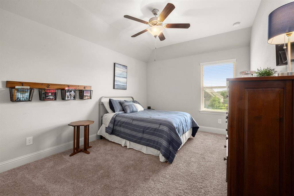 Upstairs you'll find three generously sized bedrooms with cozy carpeting, ceiling fans, and window blinds for comfort and style.