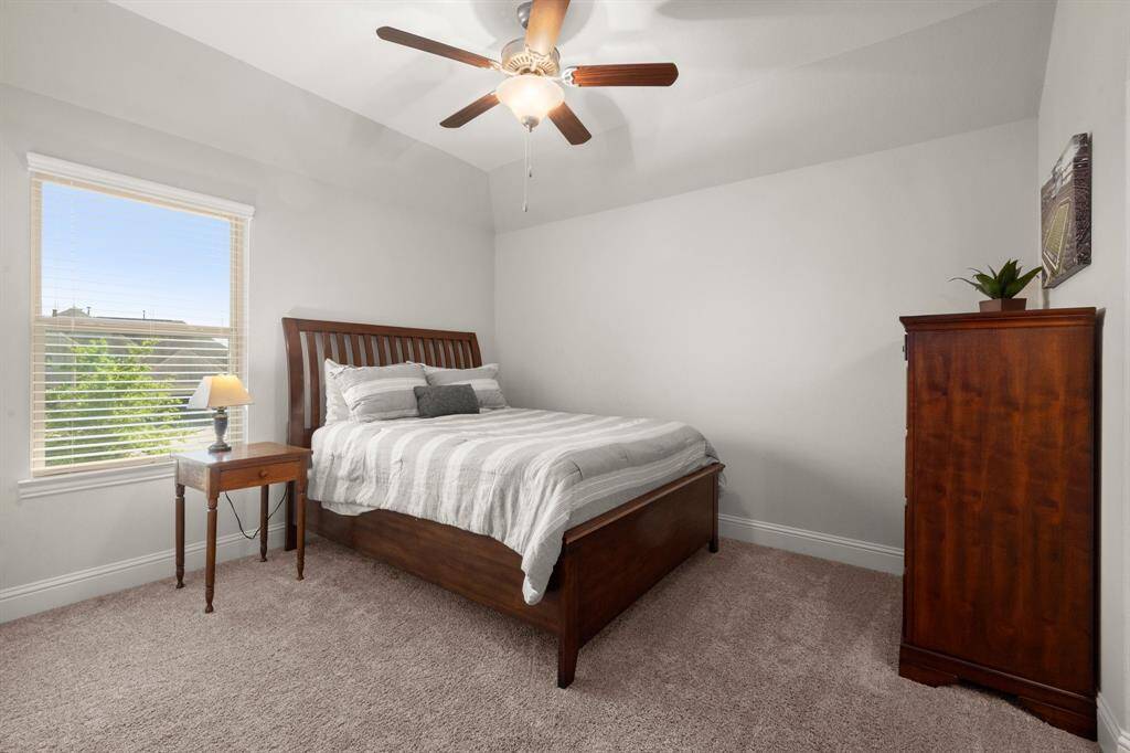 Upstairs you'll find three generously sized bedrooms with cozy carpeting, ceiling fans, and window blinds for comfort and style.