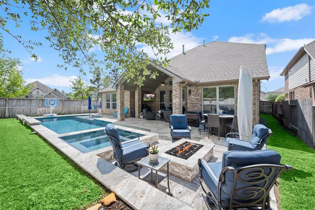 The beautifully landscaped yard offers room for entertaining, play, and unwinding in style.
