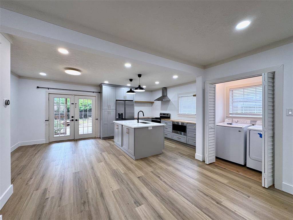 View of the dining, kitchen and laundry room. There's extra storage space right of the dryer.