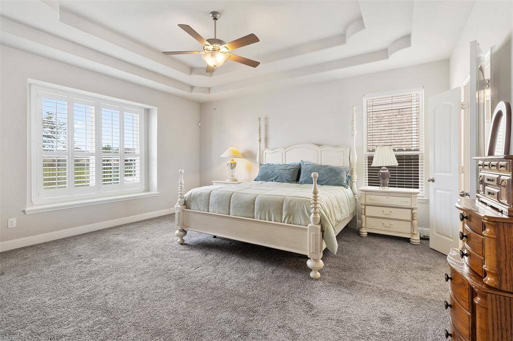 The primary bedroom features an en-suite bath with plantation shutters