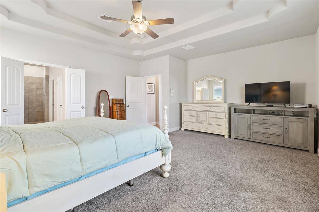The primary bedroom features an en-suite bath with plantation shutters