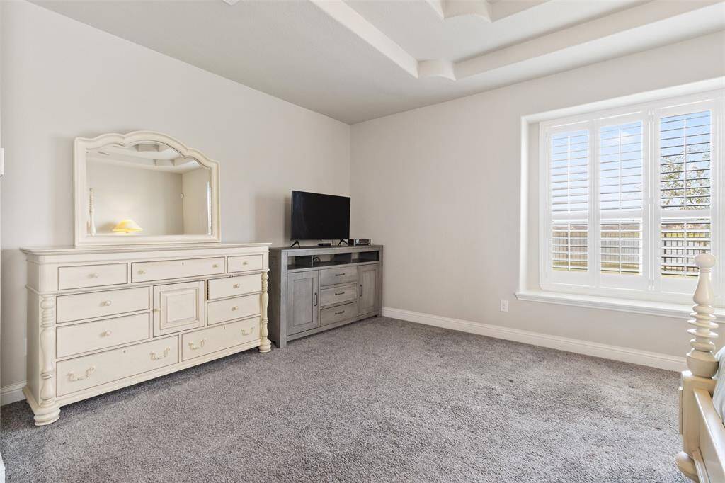The primary bedroom features an en-suite bath with plantation shutters
