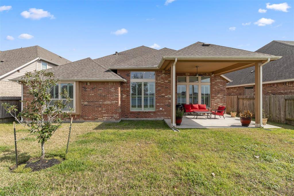 Spacious backyard and extended covered patio overlooking the lake
