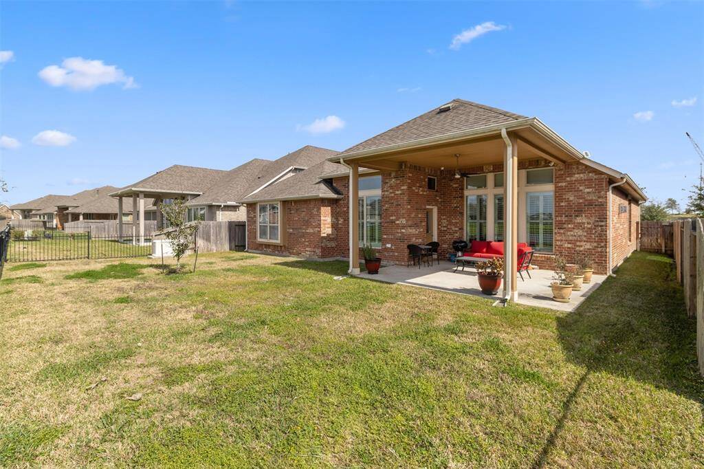 Spacious backyard and extended covered patio overlooking the lake