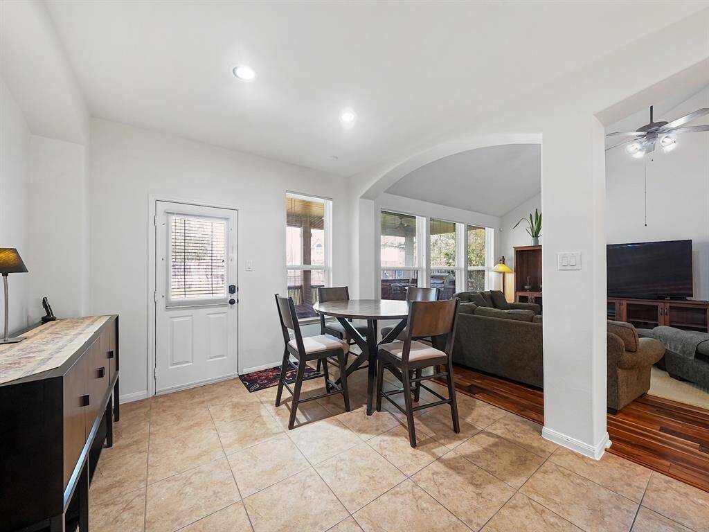 The kitchen opens to the breakfast area and living room, creating an inviting and open atmosphere for family gatherings and casual meals.