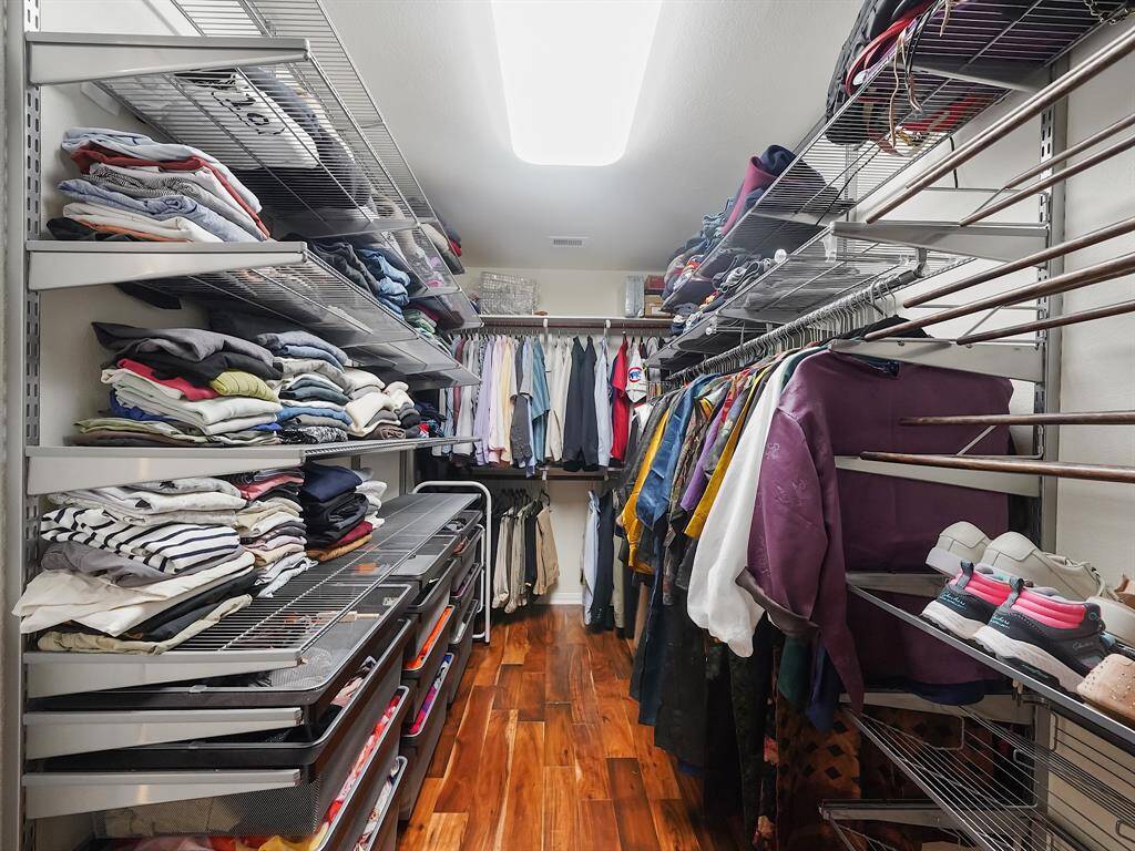 The huge walk-in closet is equipped with an Elfa closet system for optimal organization.