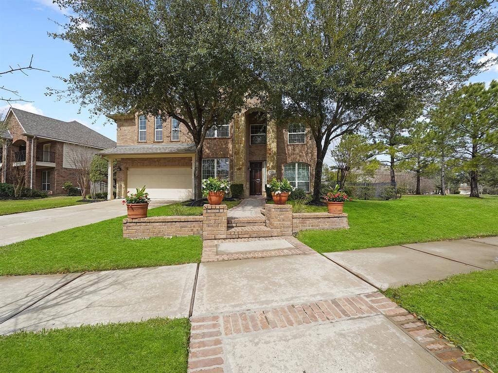 Picture yourself arriving at this picturesque home. The stunning curb appeal is accentuated by towering, mature trees creating a beautiful canopy. A charming walkway gracefully guides you to the front door, promising a welcoming and comfortable haven inside.