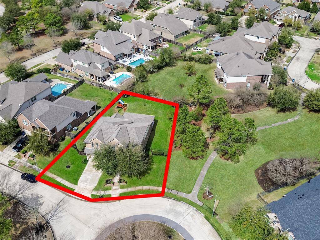 Aerial view of the home showcasing the oversized lot and walking trail next to the home! Excellent area!