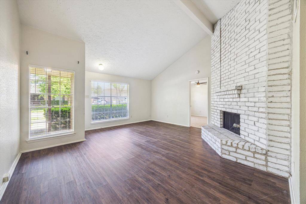 Cozy white fireplace accompanies the open living area