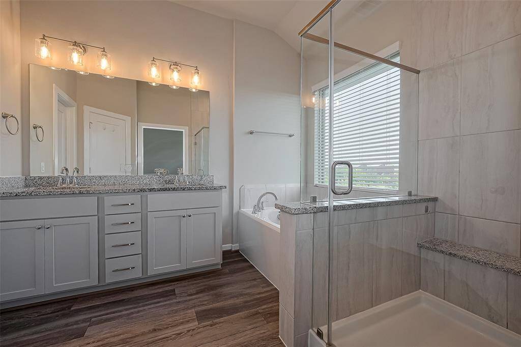 Granite counter tops, chic lighting, and neutral tile surround complete the look.