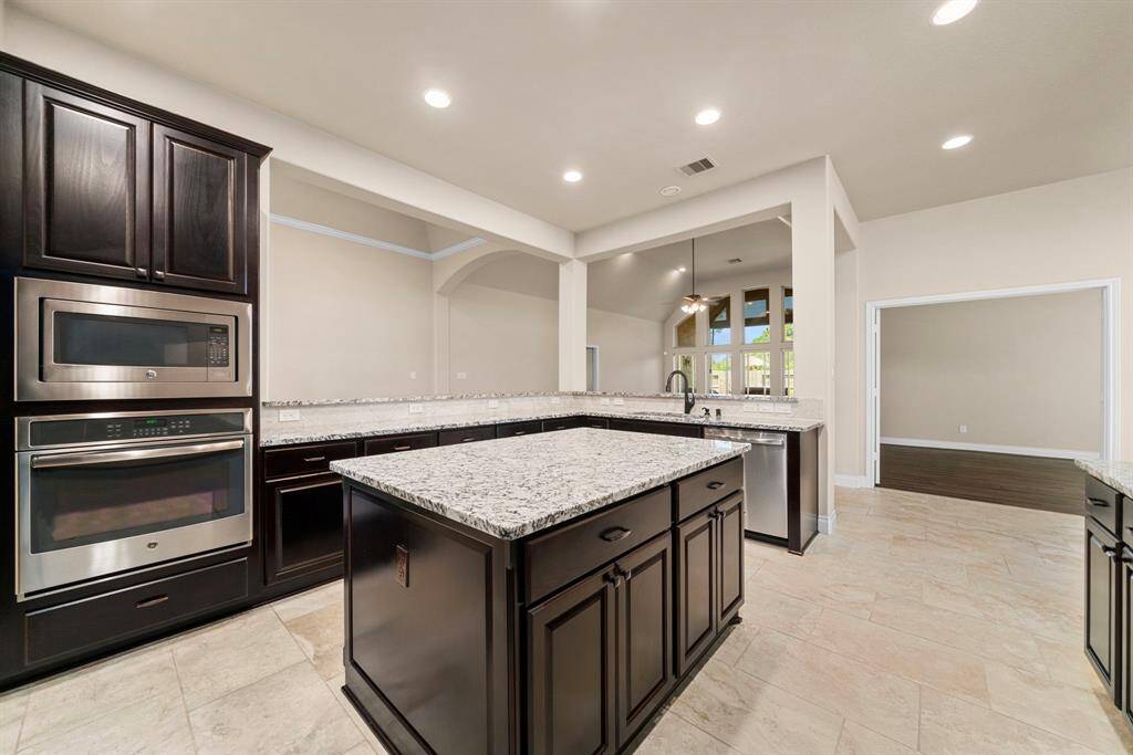 Enjoy an open-concept layout that connects the kitchen to the living and dining areas, ideal for everyday living and entertaining. The expansive wraparound counter offers plenty of workspace and bar seating potential.