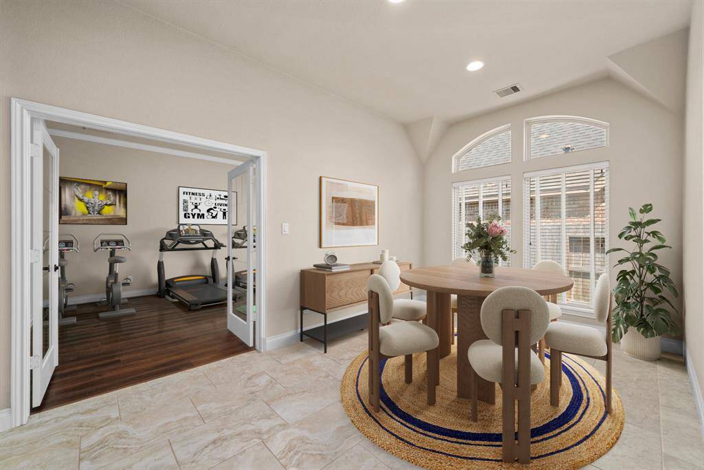 This inviting breakfast room is framed by French doors and a wall of tall windows that fill the space with natural light. Its location just off the kitchen makes it perfect for casual meals or morning coffee with a view. *Virtual Staged*