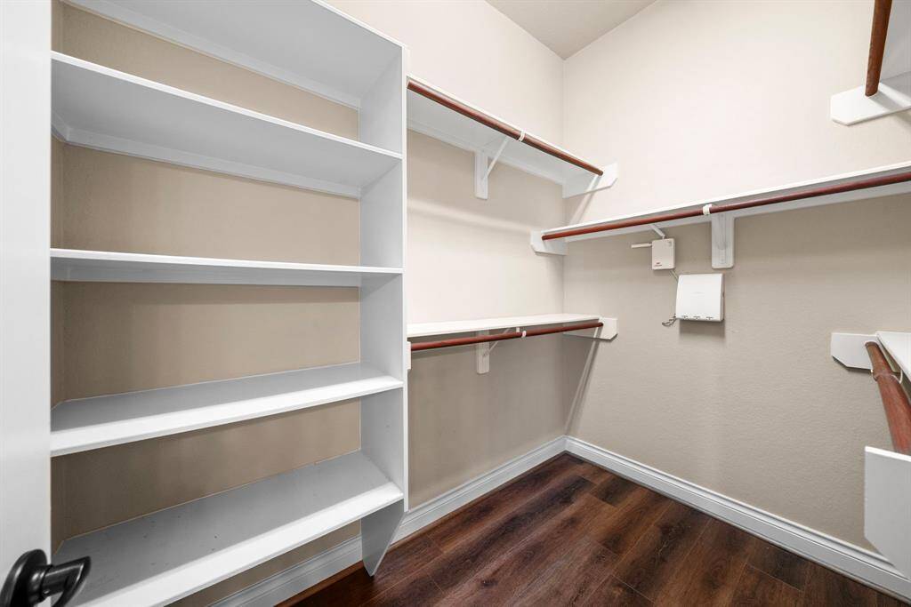 A generous His & Her closets offers ample built-in shelving and double hanging rods for optimal organization. Whether storing seasonal wardrobes or daily essentials, there’s room for everything.