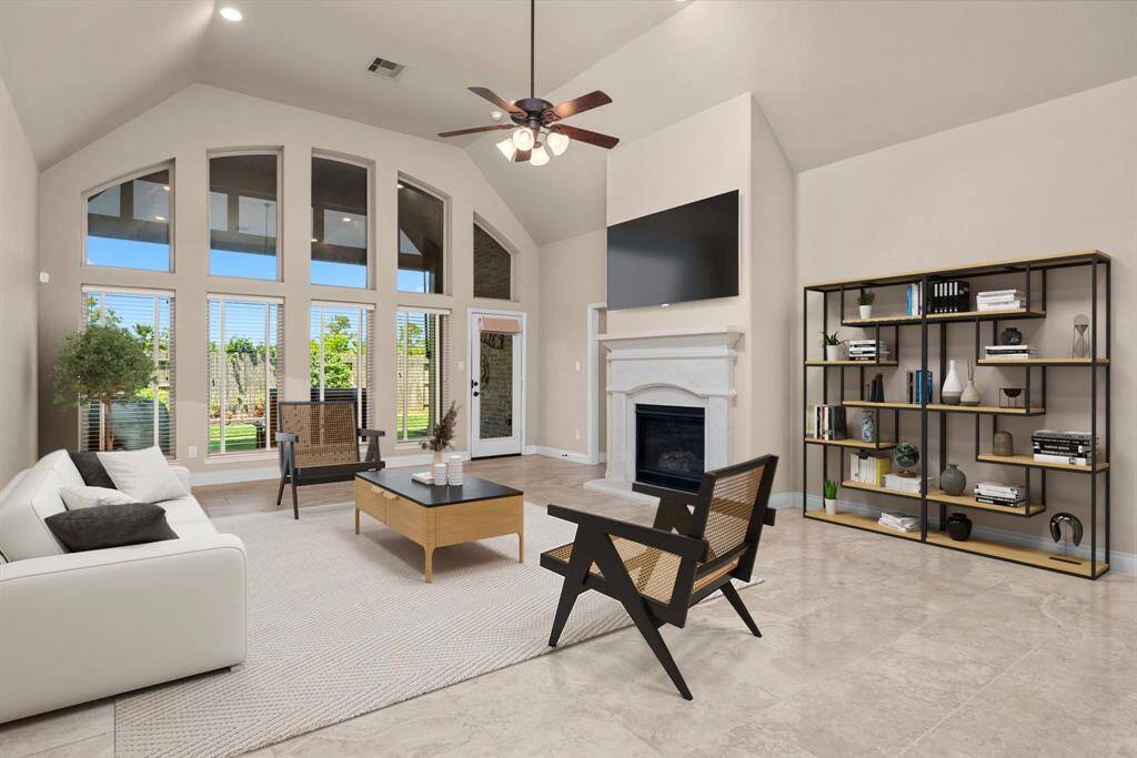 Soaring ceilings and a wall of windows bring in an abundance of natural light while offering stunning views of the backyard. This open and inviting space is ideal for entertaining or enjoying peaceful afternoons. *Virtual Staged*
