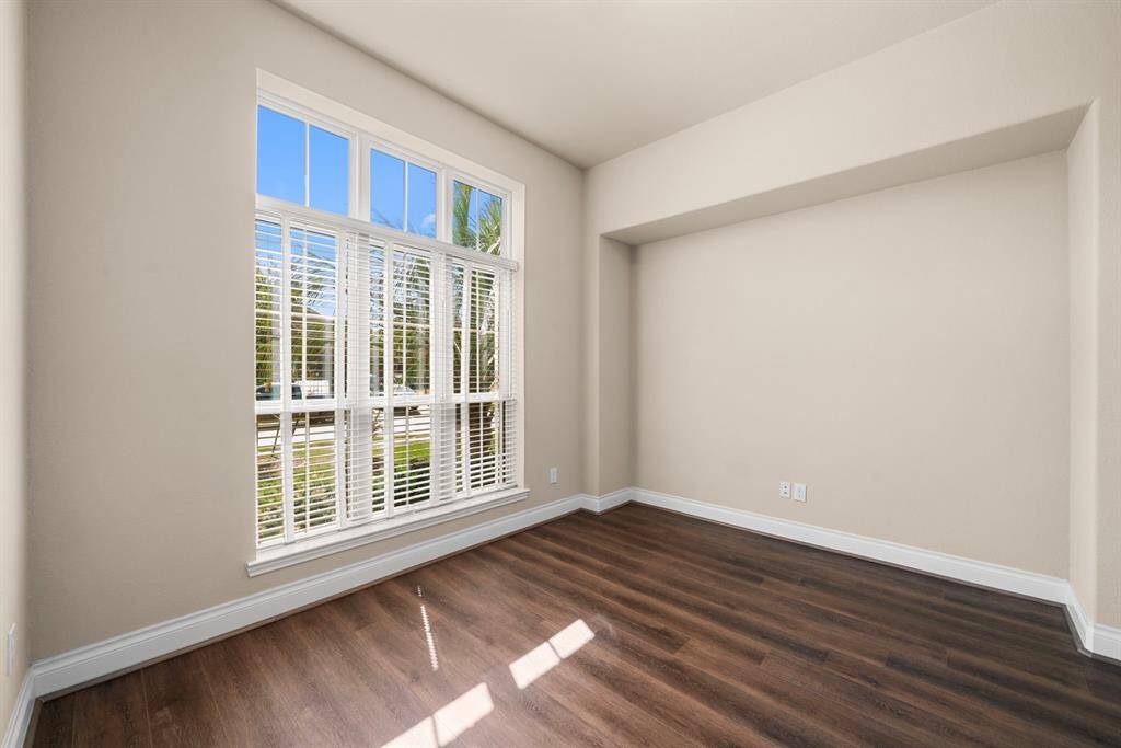Just off the entryway, this flexible front room can serve as a home office, playroom, or formal living area. Large windows provide peaceful views of the front yard and flood the space with natural light.