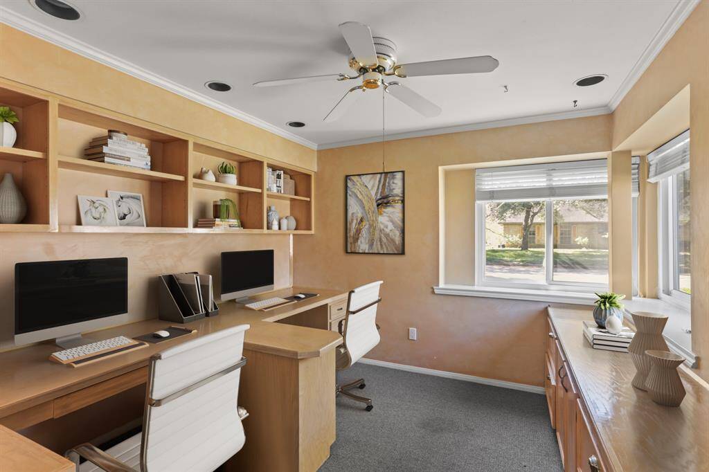 Virtually Staged: Quietly tucked away in the front of the home is this gorgeous office featuring plush carpet, lots of windows that let in plenty of natural light, and ceiling fan.