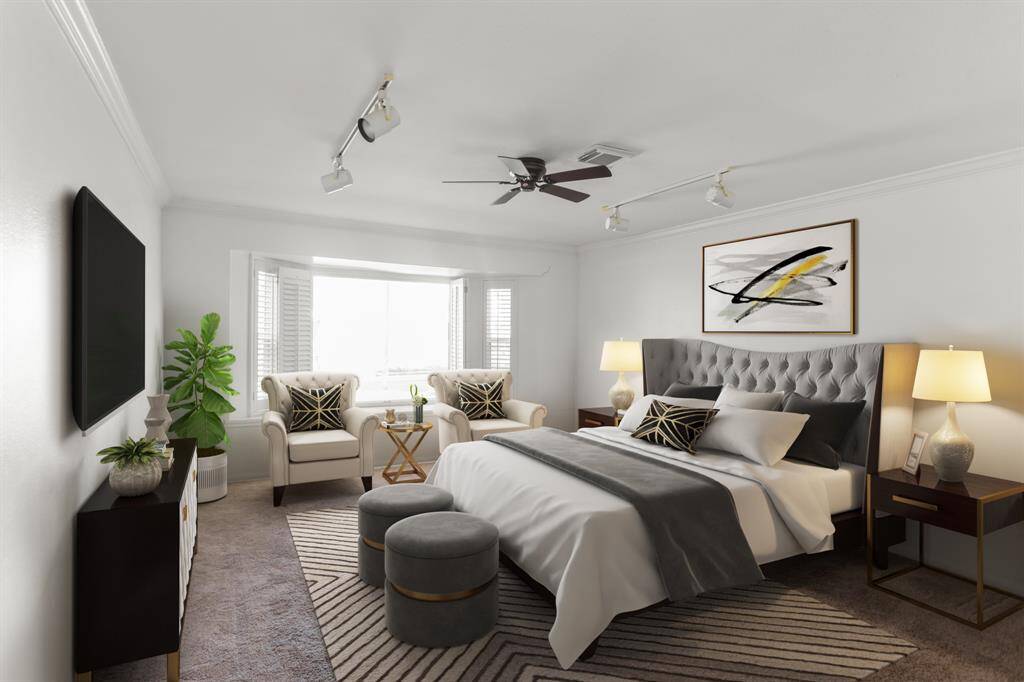 Virtually Staged: A great place to rest after a long day! This magnificent master suite features plush carpet, sitting area, beautiful dark stained ceiling fan, crown molding, and a large window.